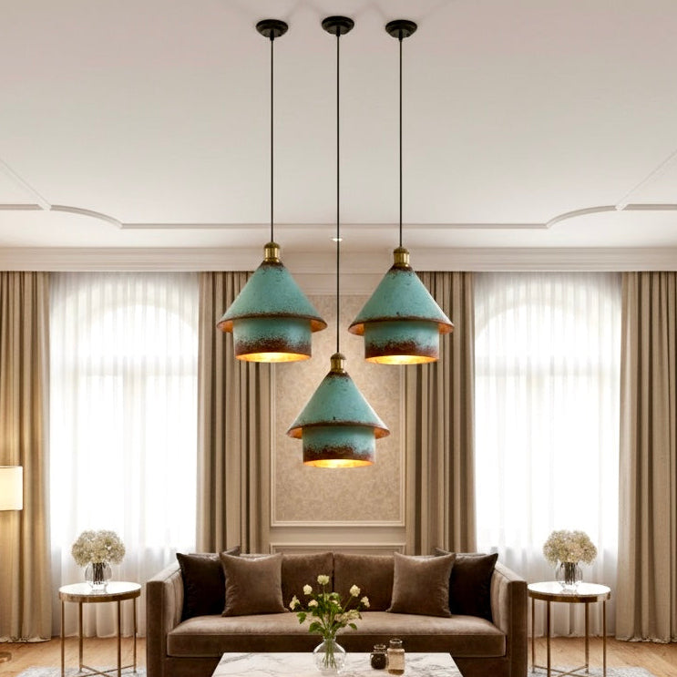 A modern rustic verdigris patina light fixture hanging in a luxury living room with high ceilings and neutral tones