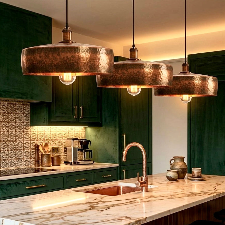 Handcrafted hammered copper pendant light with a warm red finish for kitchen island
