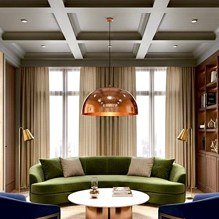Oversized copper dome ceiling light in a cozy living room with green sofa and high-end decor