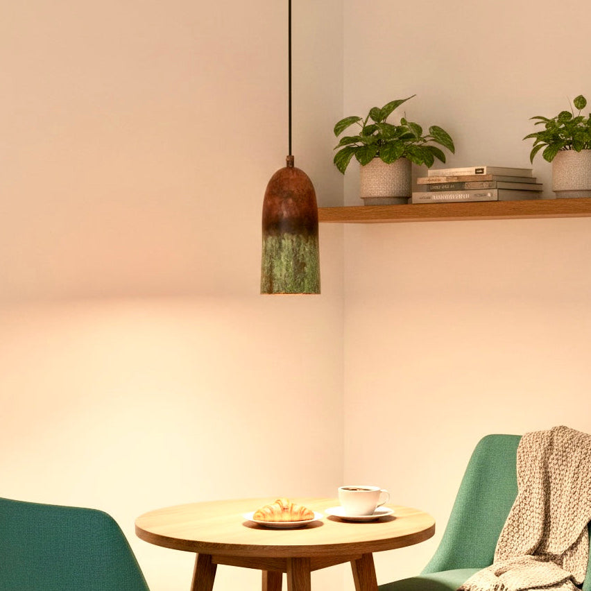 Creative cluster of four patina copper pendant lights in a high-ceiling modern living room
