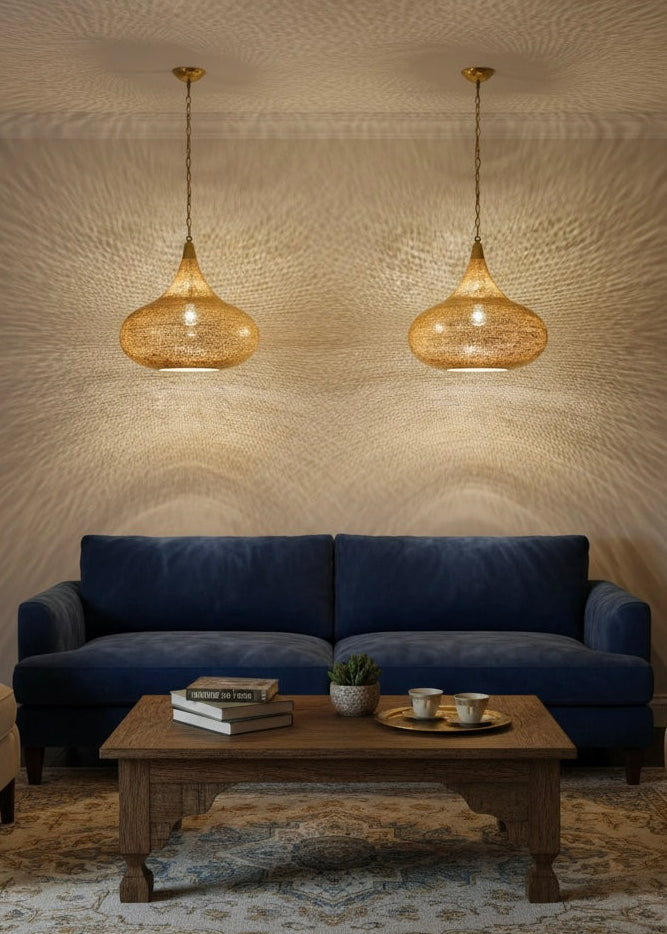 Teardrop-shaped Moroccan ceiling lamp made of antique brass, hanging on a gold chain.