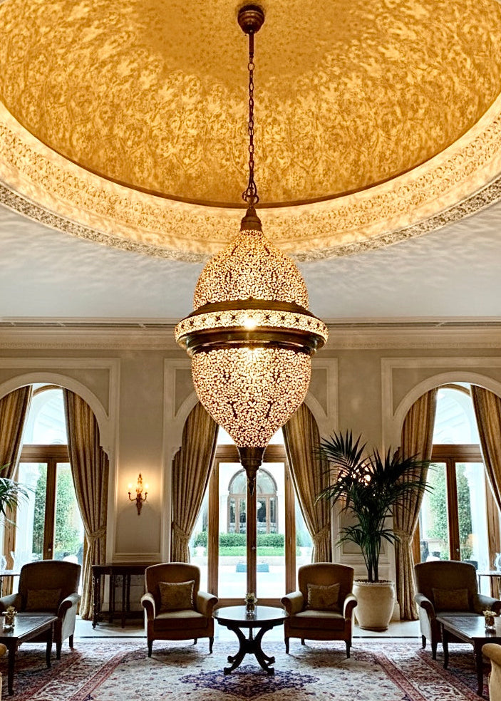 Intricate brass hanging lamp from Morocco, perfect for grand entryways or living rooms.