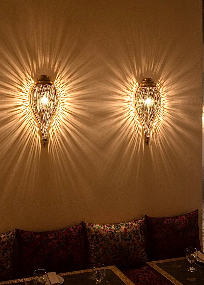 Moroccan Brass Lamp casting warm geometric shadow patterns on a white wall.