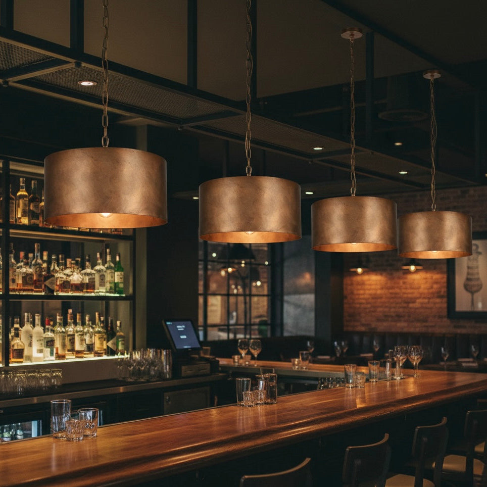 Bottom view of copper dome light fixture with warm glowing bulb.