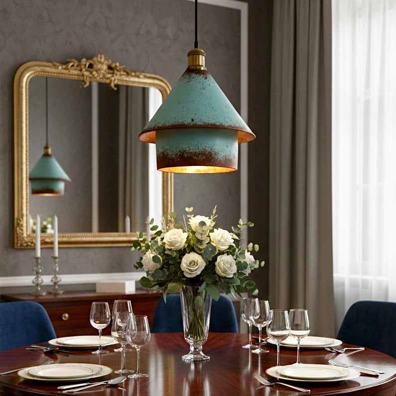Industrial style verdigris green hanging lamp over a round wooden dining table, creating an elegant rustic ambiance