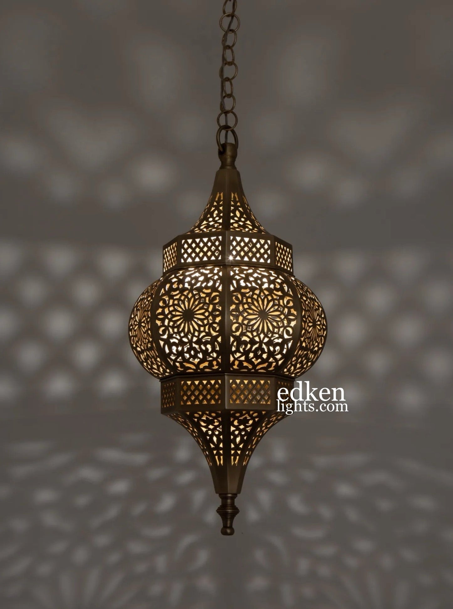 Moroccan brass ceiling light turned on, casting exotic shadows on walls.