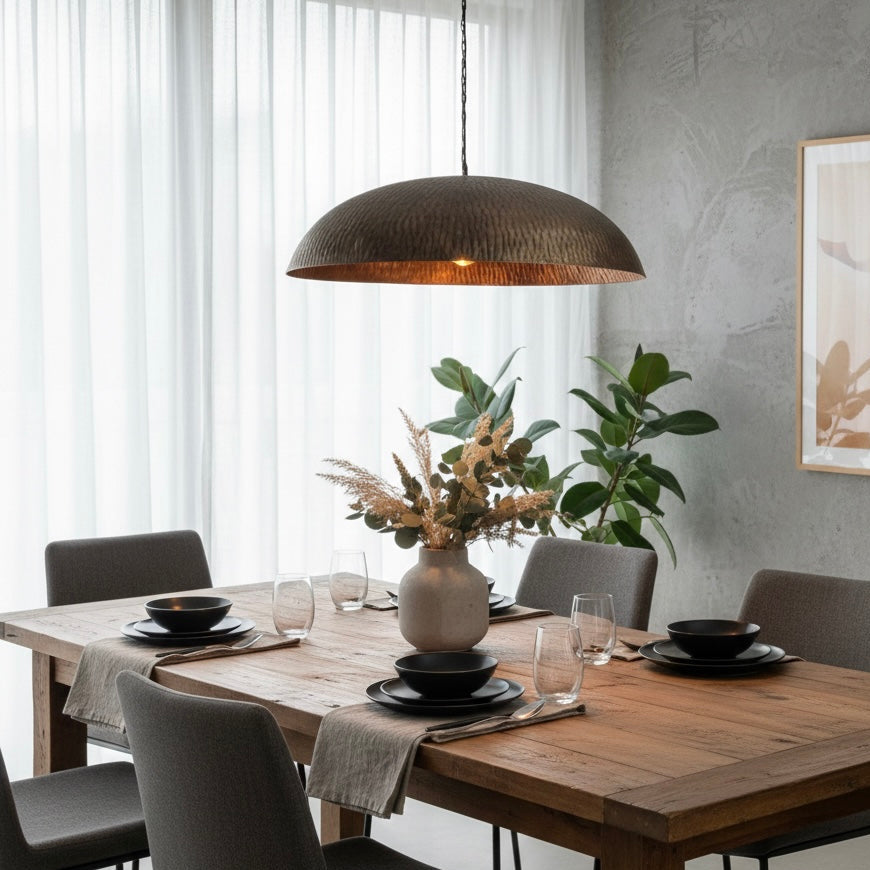 Warm gold interior of a hammered brass dome light reflecting soft ambient glow.