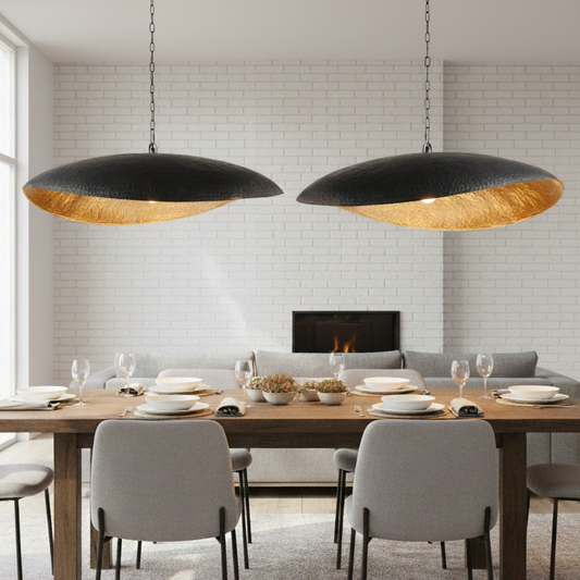 Warm golden ambient glow from a black brass pendant light turned on at night.