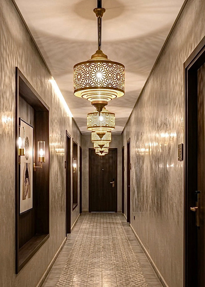 A row of Moroccan brass ceiling lamps installed in a luxury hotel hallway, ideal for wholesale commercial projects.