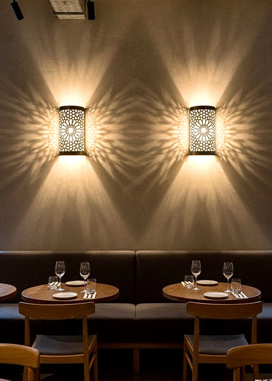 Pair of Moroccan brass lamps installed in a modern restaurant setting for wholesale hospitality lighting.