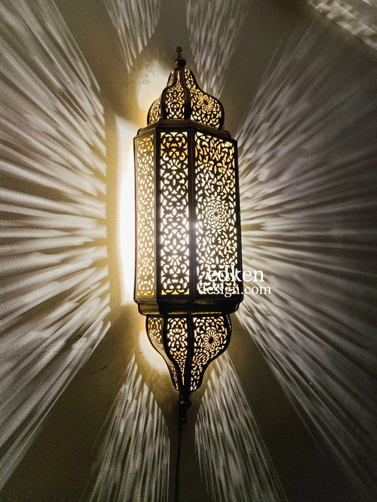 Handcrafted Moroccan wall lamp in 100% solid brass, featuring intricate hand-pierced geometric patterns for a warm glow.