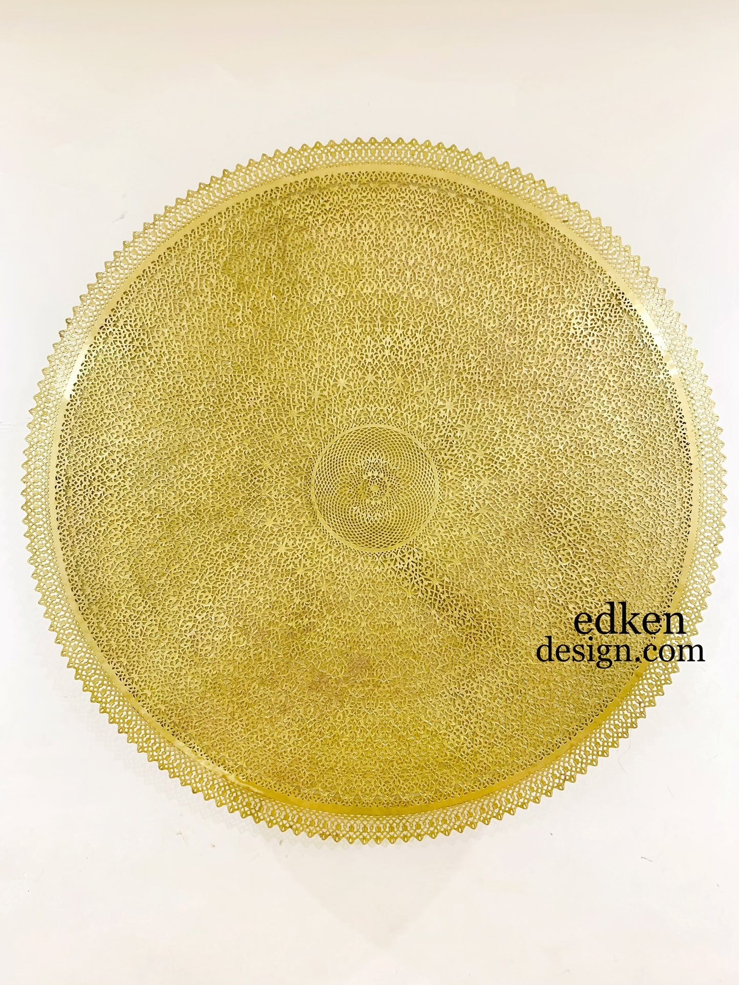 Elegant gold-finished Moroccan wall light fixture, ornate circular Brass carving for luxury home interior and ambient mood lighting.