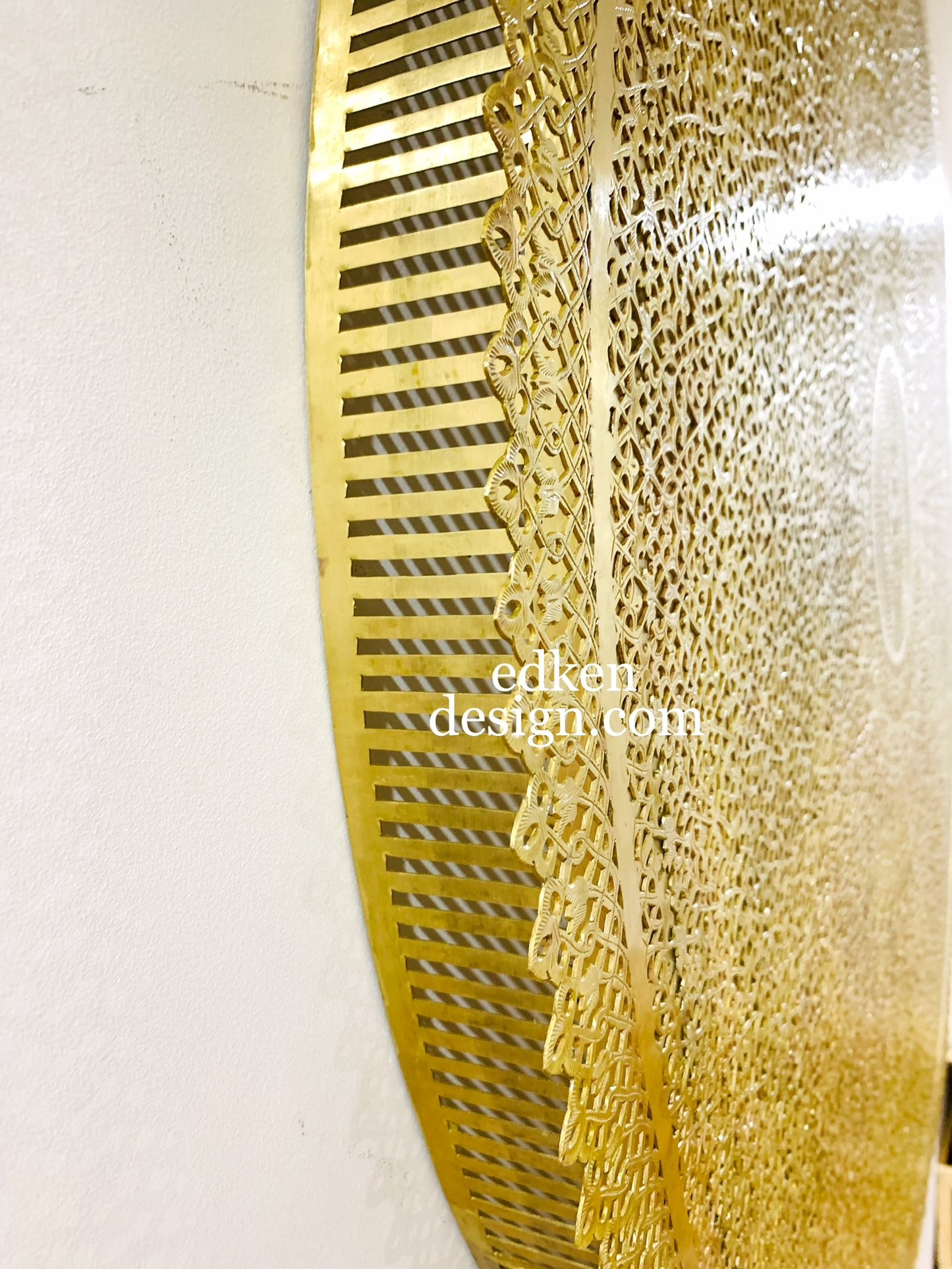 Large handmade Moroccan brass wall lamp with intricate geometric patterns, providing a warm ambient glow, Edken lights.