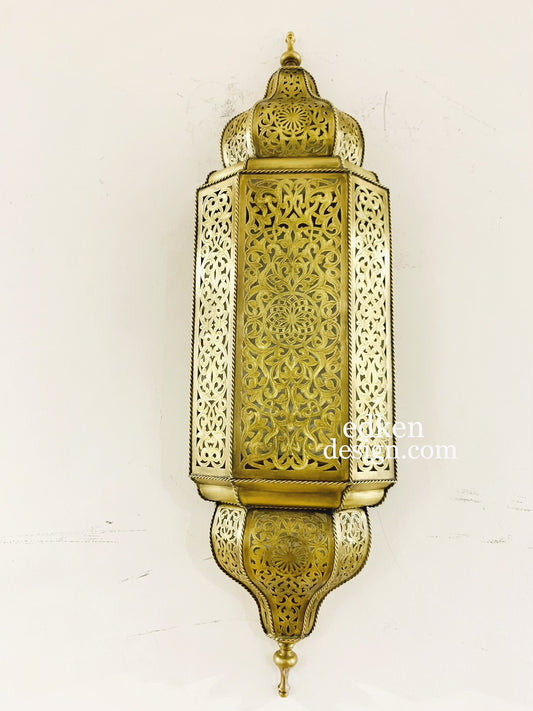 Authentic Moroccan brass sconce with detailed hand-engravings, projecting beautiful shadow play on the wall.
